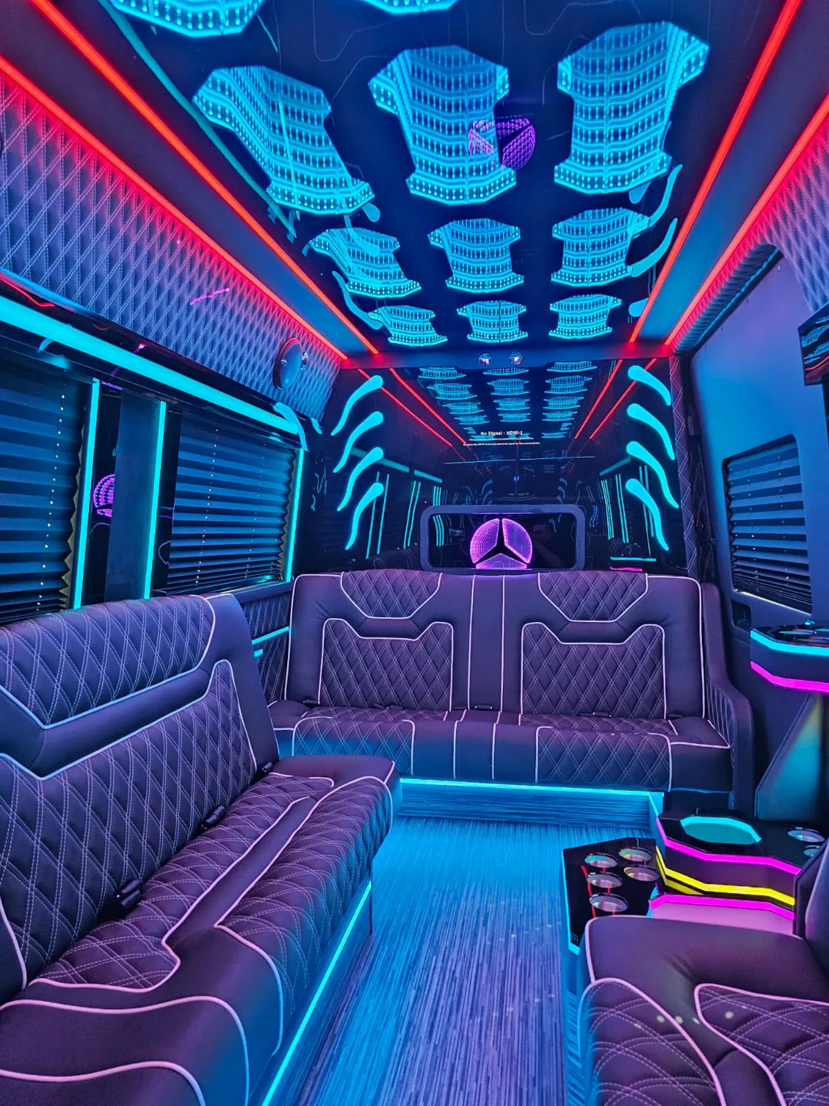 Limo Sprinter perimeter lounge seating with blue and red ambient lighting