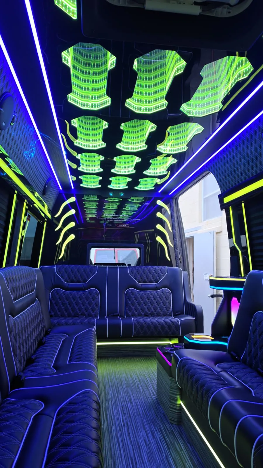 Limo Sprinter perimeter lounge seating with blue and green cabin lighting